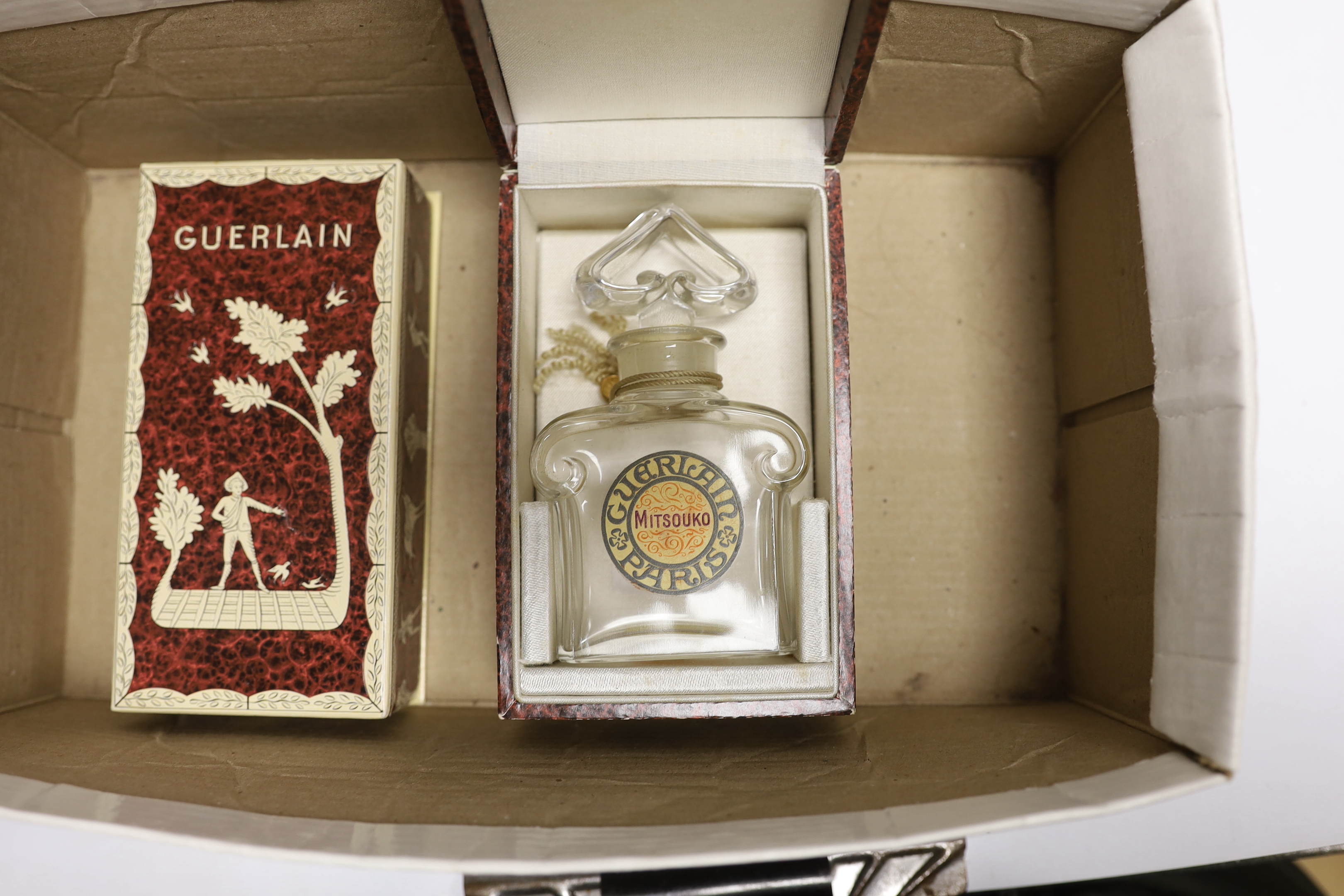 A collection of Guerlain perfume bottles, some with cases, including ‘Liu’